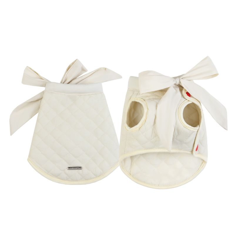 Two beige pet quilted shirt with bow ties on a white background