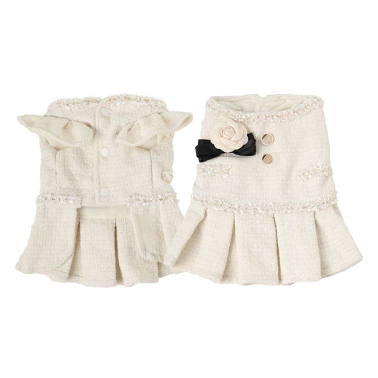 Pair of cream-colored pet tweed dress with decorative elements on a white background