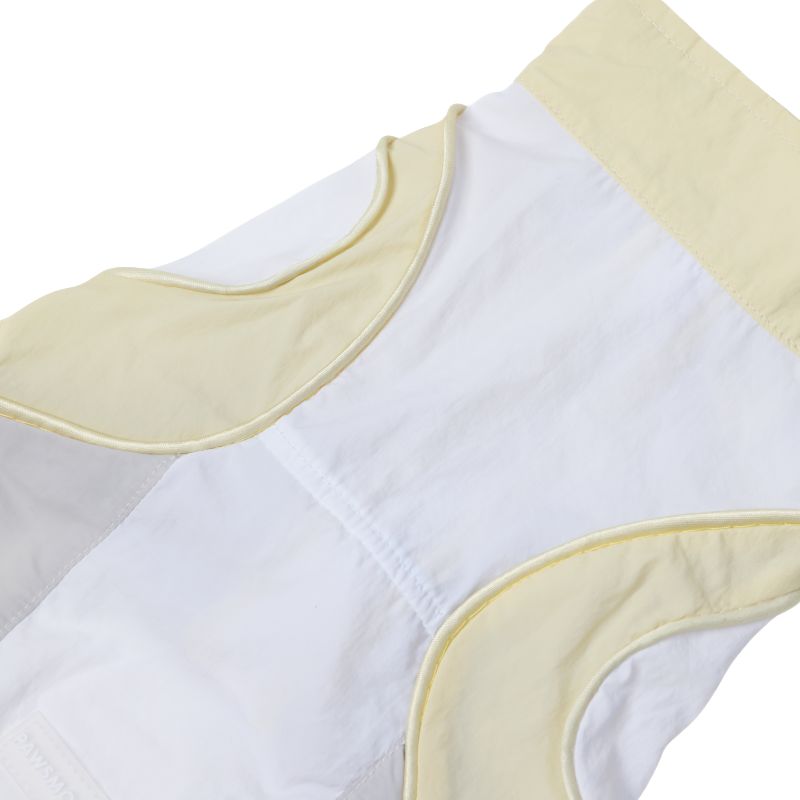 Close-up of a white garment with yellow trim on a white background